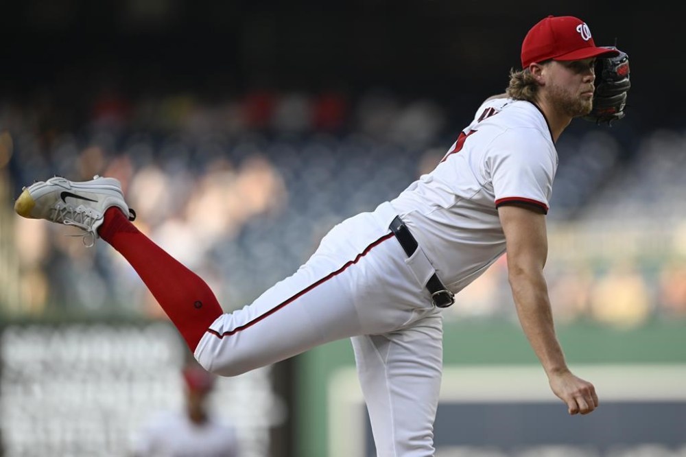 Washington Nationals starting pitcher Jake Irvin watches a throw to an Arizona Diamondbacks batter during the first inning of a baseball game Tuesday, June 18, 2024, in Washington. (AP Photo/John McDonnell)