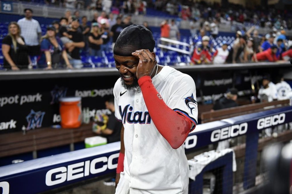 Miami Marlins' Vidal Bruján smiles after hitting a single to drive in the winning run during the 10th inning of the team's baseball game against the St. Louis Cardinals, Tuesday, June 18, 2024, in Miami. (AP Photo/Michael Laughlin)