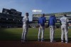 Kansas City Royals manager Matt Quatraro, left, observes a moment of silence with coaches and players for former MLB player Willie Mays before a baseball game between the Oakland Athletics and the Royals in Oakland, Calif., Tuesday, June 18, 2024. (AP Photo/Jeff Chiu)