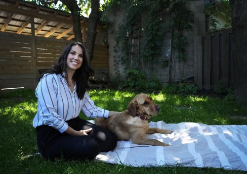 Victim Services Toronto employee Megan Ireland and Labrador retriever Penny pose for a photograph in Toronto on Friday, June 14, 2024. THE CANADIAN PRESS/Nathan Denette