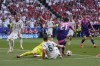 Germany's Ilkay Gundogan (21) controls the ball next to Hungary's goalkeeper Peter Gulacsi, left, and Willi Orban (6) during a Group A match between Germany and Hungary at the Euro 2024 soccer tournament in Stuttgart, Germany, Wednesday, June 19, 2024. (AP Photo/Darko Vojinovic)