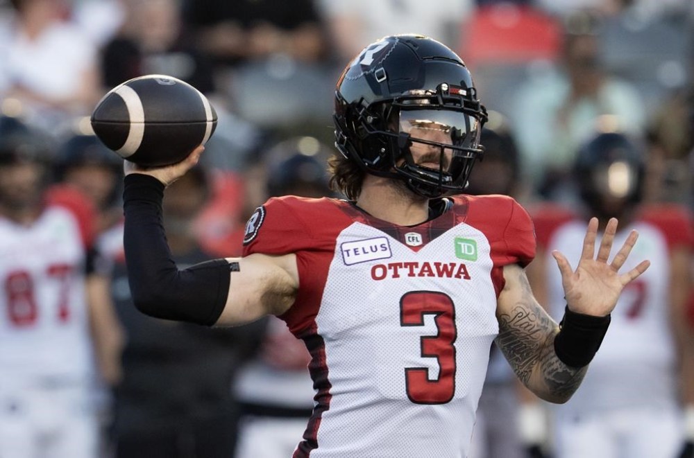 Starting Thursday night, broadcasts of CFL games on TSN+ will be available as augmented live streams. Viewers will see locators to help them find the ball carrier and a timer that will indicate the length of time it takes a quarterback to get a pass off. Ottawa RedBlacks quarterback Dru Brown attempts a pass against the Montreal Alouettes during first-half CFL pre-season action, Friday, May 31, 2024 in Ottawa. THE CANADIAN PRESS/Adrian Wyld