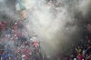 Smoke engulfs Albanian fans after Albania's Nedim Bajrami scored his side's opening goal during a Group B match between Italy and Albania at the Euro 2024 soccer tournament in Dortmund, Germany, Saturday, June 15, 2024. (AP Photo/Andreea Alexandru)