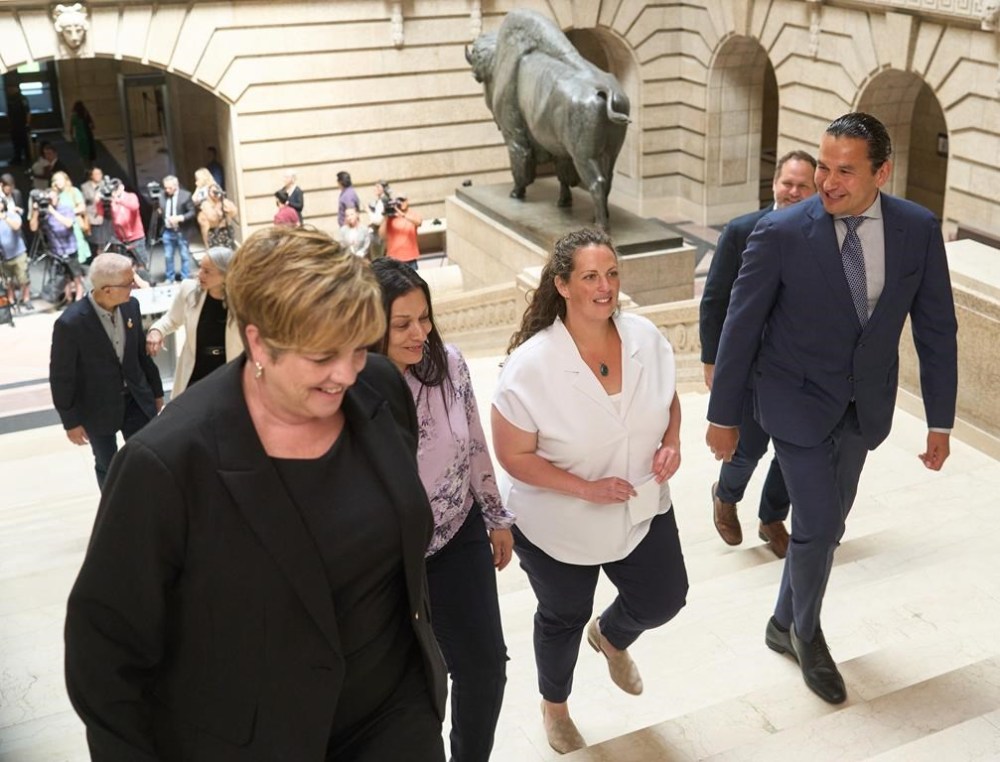 MLA-elect Carla Compton walks alongside Premier Wab Kinew and members of the NDP caucus at the Manitoba legislature in Winnipeg, Wednesday June 19, 2024. THE CANADIAN PRESS/David Lipnowski