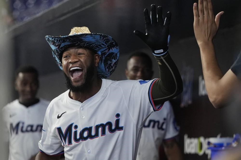 Miami Marlins' Bryan De La Cruz smiles after hitting a solo home run during the first inning of a baseball game against the St. Louis Cardinals, Wednesday, June 19, 2024, in Miami (AP Photo/Marta Lavandier)