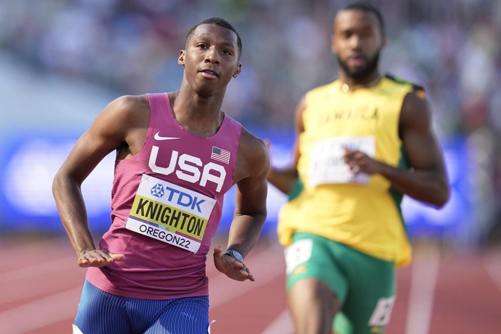 FILE - Erriyon Knighton, of the United States, left, wins a heat in the men's 200-meter run at the World Athletics Championships on Monday, July 18, 2022, in Eugene, Ore. Sprinter Erriyon Knighton tested positive for a banned substance that an arbitration panel determined came from contaminated meat, a decision that keeps the 200-meter specialist eligible to run at the upcoming Olympic trials, Wednesday, June 19, 2024. (AP Photo/Ashley Landis, File)
