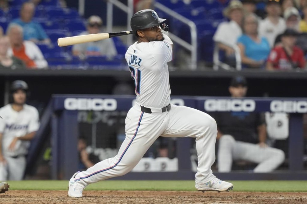 Miami Marlins' Otto Lopez (61) hits a single to right field to bring in the winning run during the ninth inning of a baseball game against the St. Louis Cardinals, Wednesday, June 19, 2024, in Miami. The Marlins defeated the Cardinals 4-3. (AP Photo/Marta Lavandier)