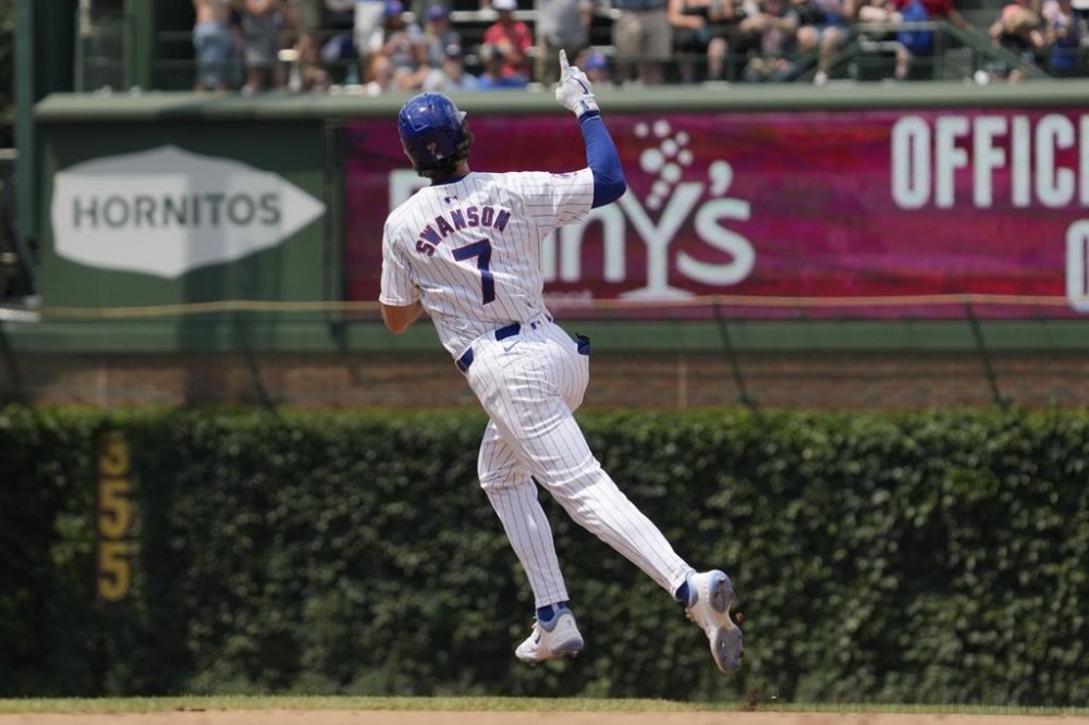 Chicago Cubs' Dansby Swanson celebrates as he rounds the bases after hitting a solo home run during the fourth inning of a baseball game against the San Francisco Giants in Chicago, Wednesday, June 19, 2024. (AP Photo/Nam Y. Huh)