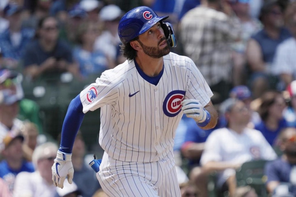 Chicago Cubs' Dansby Swanson watches his solo home run during the fourth inning of a baseball game against the San Francisco Giants in Chicago, Wednesday, June 19, 2024. (AP Photo/Nam Y. Huh)
