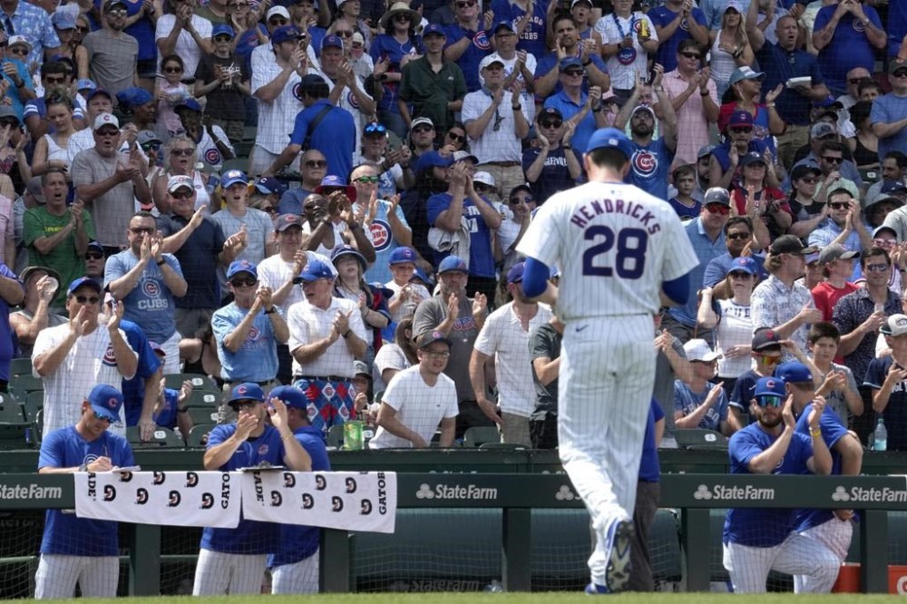 Chicago Cubs fans cheer Chicago Cubs pitcher Kyle Hendricks as he leaves during the sixth inning of a baseball game against the San Francisco Giants in Chicago, Wednesday, June 19, 2024. (AP Photo/Nam Y. Huh)
