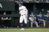 Texas Rangers' Robbie Grossman scores on a bases loaded hit by a pitch thrown by New York Mets pitcher Sean Manaea during the first inning of a baseball game, Wednesday, June 19, 2024, in Arlington, Texas. (AP Photo/Julio Cortez)