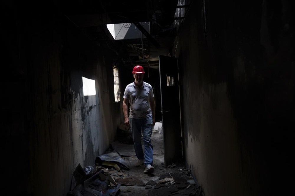 Store manager Oleksandr Lutsenko walks inside the Epicenter shopping complex in Kharkiv, Ukraine, Thursday, June 6, 2024. The bombing of the Epicenter with glide bombs by the Russian military in May killed 19 people, including two children. In all, glide bombs have hit the city more than 50 times in 2024, according to Spartak Borysenko of the Kharkiv regional prosecutor's office. (AP Photo/Evgeniy Maloletka)