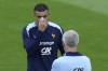 France's Kylian Mbappe, left, gestures as he speaks with his head coach Didier Deschamps during a training session in Paderborn, Germany, Wednesday, June 19, 2024. France will play against Netherland during their Group D soccer match at the Euro 2024 soccer tournament on June 21. (AP Photo/Hassan Ammar)