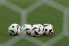 The Adidas FUSSBALLLIEBE - meaning “love of football” in German - and the official match ball of the European Championship sit on the pitch before a Group A match between Germany and Hungary at the Euro 2024 soccer tournament in Stuttgart, Germany, Wednesday, June 19, 2024. (Spada/LaPresse via AP)