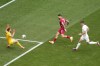 Slovenia's goalkeeper Jan Oblak saves a shot from Serbia's Aleksandar Mitrovic, center, during a Group C match between Slovenia and Serbia at the Euro 2024 soccer tournament in Munich, Germany, Thursday, June 20, 2024. (AP Photo/Ariel Schalit)