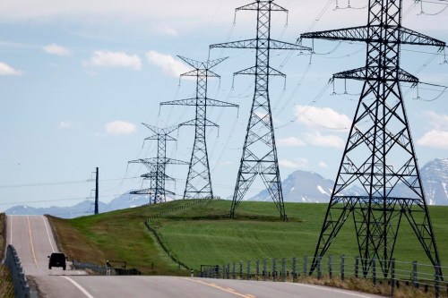 Power transmission lines are seen with the Rocky Mountains in the background near Pincher Creek, Alta., Thursday, June 6, 2024. THE CANADIAN PRESS/Jeff McIntosh