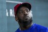 New York Mets outfielder Adolis Garcia looks on from the dugout during the fifth inning of a baseball game against the New York Mets, Tuesday, June 18, 2024, in Arlington, Texas. (AP Photo/Julio Cortez)
