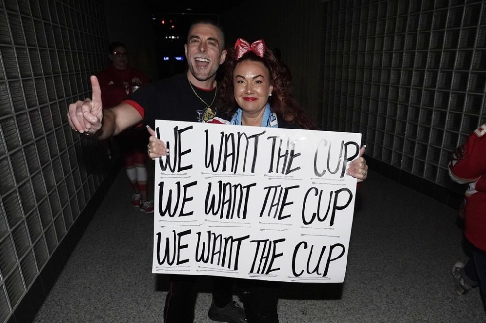 Florida Panthers fans Jessyca and Joseph Grella of Hollywood, Fla., arrive at the arena before Game 5 of the NHL hockey Stanley Cup Finals against the Edmonton Oilers, Tuesday, June 18, 2024, in Sunrise, Fla. (AP Photo/Wilfredo Lee)