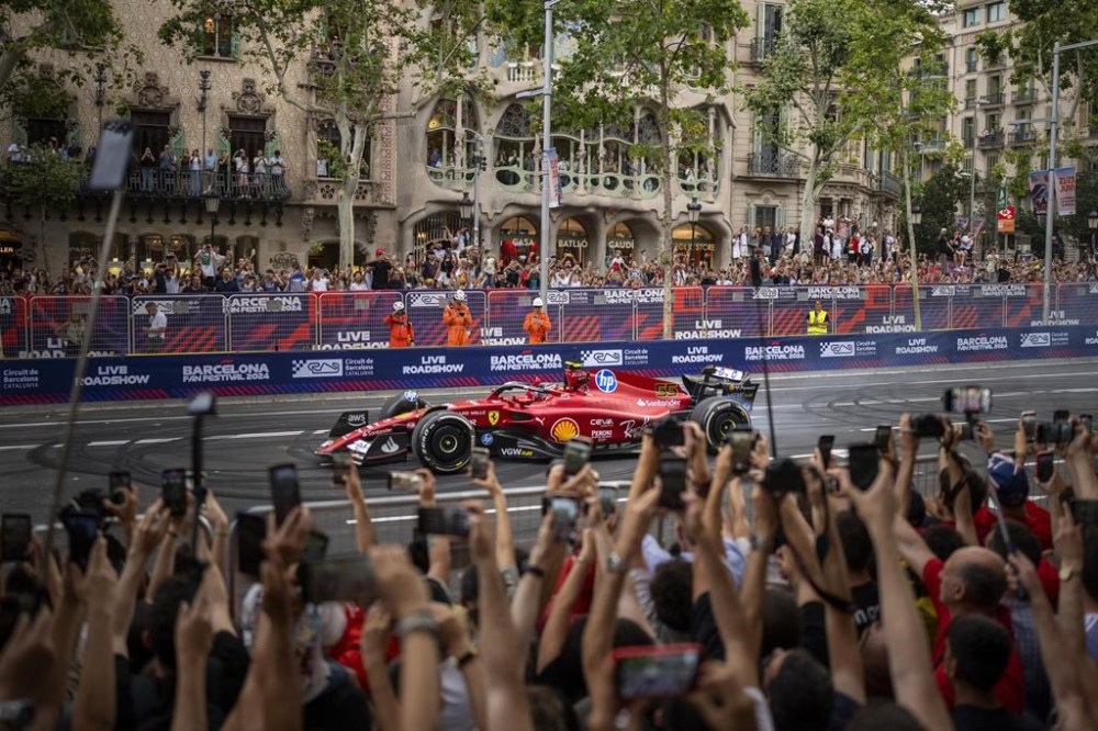Ferrari's Carlos Sainz of Spain drives during the Formula 1 Barcelona Fan Festival along the Passeig de Gracia in downtown Barcelona, Spain, Wednesday, June 19, 2024. (AP Photo/Emilio Morenatti)