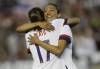 FILE - U.S.forward Christen Press hugs forward Tobin Heath, left, for Heath's goal against Ireland during the first half of an international friendly soccer match in Pasadena, Calif., Saturday, Aug. 3, 2019. Christen Press and Tobin Heath are back. OK, maybe not on the field quite yet, but their popular YouTube and podcast series, the RE-CAP show, has returned just in time for this summer’s Olympics. (AP Photo/Alex Gallardo, File)