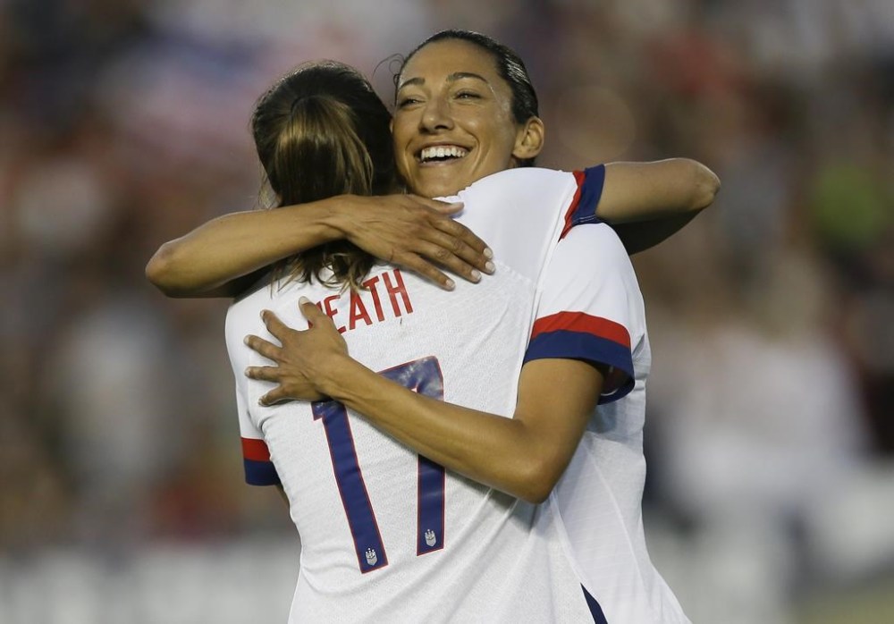 FILE - U.S.forward Christen Press hugs forward Tobin Heath, left, for Heath's goal against Ireland during the first half of an international friendly soccer match in Pasadena, Calif., Saturday, Aug. 3, 2019. Christen Press and Tobin Heath are back. OK, maybe not on the field quite yet, but their popular YouTube and podcast series, the RE-CAP show, has returned just in time for this summer’s Olympics. (AP Photo/Alex Gallardo, File)