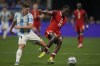 Argentina's Julian Alvarez, left, and Canada's Moise Bombito battle for the ball during a Copa America Group A soccer match in Atlanta, Thursday, June 20, 2024. THE CANADIAN PRESS/AP/Jason Allen