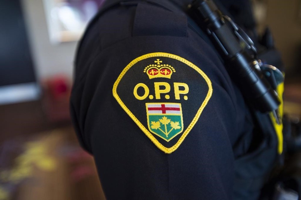 Police say they are investigating after four people were found dead at a rural home in southwestern Ontario. An Ontario Provincial Police crest is displayed on the arm of an officer during a press conference in Vaughan, Ont., on Thursday, June 20, 2019. THE CANADIAN PRESS/Andrew Lahodynskyj
