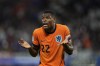 Denzel Dumfries of the Netherlands protest to referee Anthony Taylor of England, after a goal scored by a teammate Nathan Ake was disallowed during a Group D match between the Netherlands and France at the Euro 2024 soccer tournament in Leipzig, Germany, Friday, June 21, 2024. (AP Photo/Mathias Schrader)