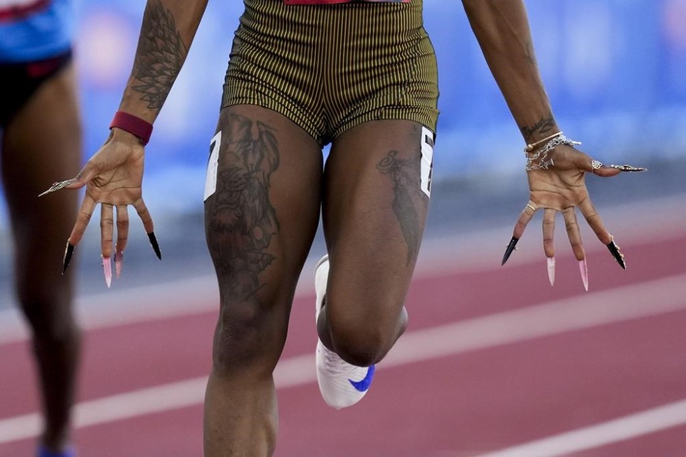 Sha'Carri Richardson wins a heat women's 100-meter run during the U.S. Track and Field Olympic Team Trials Friday, June 21, 2024, in Eugene, Ore. (AP Photo/Charlie Neibergall)