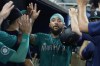 Seattle Mariners' J.P. Crawford (3) scores during the first inning of a baseball game against the Miami Marlins, Friday, June 21, 2024, in Miami. (AP Photo/Marta Lavandier)