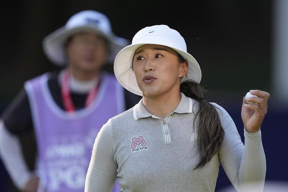 Amy Yang, of South Korea, holds her ball after finishing the 18th hole, her last of the day, during the second round of the Women's PGA Championship golf tournament at Sahalee Country Club, Friday, June 21, 2024, in Sammamish, Wash. (AP Photo/Gerald Herbert)