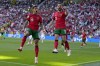 Portugal's Bernardo Silva, right, celebrates with Joao Cancelo after scoring the opening goal of his team, during a Group F match between Turkey and Portugal at the Euro 2024 soccer tournament in Dortmund, Germany, Saturday, June 22, 2024. (AP Photo/Themba Hadebe)