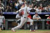Washington Nationals' Lane Thomas watches his RBI single against the Colorado Rockies during the seventh inning of a baseball game Saturday, June 22, 2024, in Denver. (AP Photo/Geneva Heffernan)