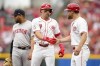 Cincinnati Reds' Spencer Steer (7) celebrates with first base coach Collin Cowgill, right, after hitting a single in the second inning of a baseball game against the Boston Red Sox in Cincinnati, Sunday, June 23, 2024. (AP Photo/Jeff Dean)