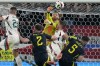Scotland's goalkeeper Angus Gunn, up, and Hungary's Barnabas Varga, center, collide during a Group A match between Scotland and Hungary at the Euro 2024 soccer tournament in Stuttgart, Germany, Sunday, June 23, 2024. (AP Photo/Matthias Schrader)