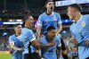 Uruguay's Maximiliano Araujo, bottom center celebrates with teammates after scoring his side's opening goal against Panama during a Copa America Group C soccer match in Miami Gardens, Fla, Sunday, June 23, 2024. (AP Photo/Rebecca Blackwell)