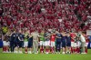 Denmark players and staff gather togheter on the pitch at the end of a Group C match between Denmark and England at the Euro 2024 soccer tournament in Frankfurt, Germany, Thursday, June 20, 2024. The game ended in a 1-1 draw. (AP Photo/Thanassis Stavrakis)
