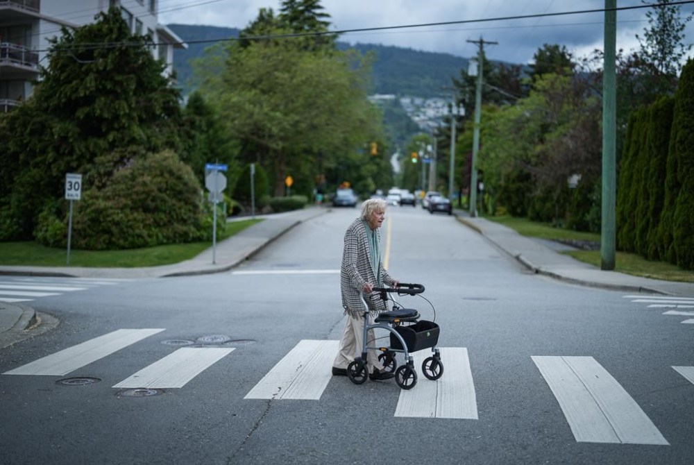 Vi Roden, who turned 101 on June 16, uses a walker as she crosses a street outside her home in West Vancouver, B.C., Friday, June 14, 2024. THE CANADIAN PRESS/Darryl Dyck