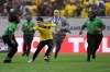 A pitch invader attempts to evade security guards at the end of a Copa America Group D soccer match between Colombia and Paraguay in Houston, Monday, June 24, 2024. (AP Photo/David J. Phillip)