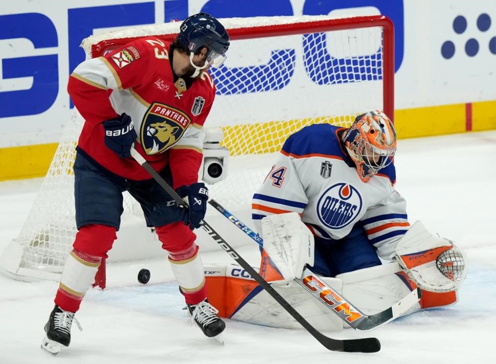 Florida Panthers forward Carter Verhaeghe (23) scores on Edmonton Oilers goaltender Stuart Skinner (74) during first period of Game 7 of the NHL Stanley Cup final in Sunrise, Fla., on Monday, June 24, 2024. THE CANADIAN PRESS/Nathan Denette