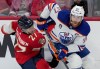 Edmonton Oilers forward Connor McDavid (97) dumps Florida Panthers forward Eetu Luostarinen (27) against the boards as he turns with the puck during second period game 7 of the NHL Stanley Cup finals in Sunrise, Fla., on Monday, June 24, 2024. THE CANADIAN PRESS/Nathan Denette