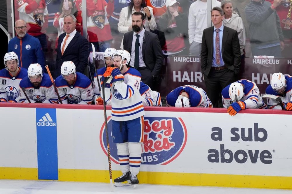 Edmonton Oilers forward Zach Hyman (18) stands in front of the bench as the Edmonton Oilers react to losing game 7 of the NHL Stanley Cup finals to the Florida Panthers in Sunrise, Fla., on Monday, June 24, 2024. THE CANADIAN PRESS/Nathan Denette