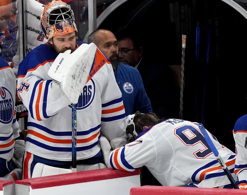 Edmonton Oilers goaltender Stuart Skinner (74) and forward Connor McDavid (97) react after losing to the Florida Panthers in game 7 of the NHL Stanley Cup finals in Sunrise, Fla., on Monday, June 24, 2024. THE CANADIAN PRESS/Nathan Denette