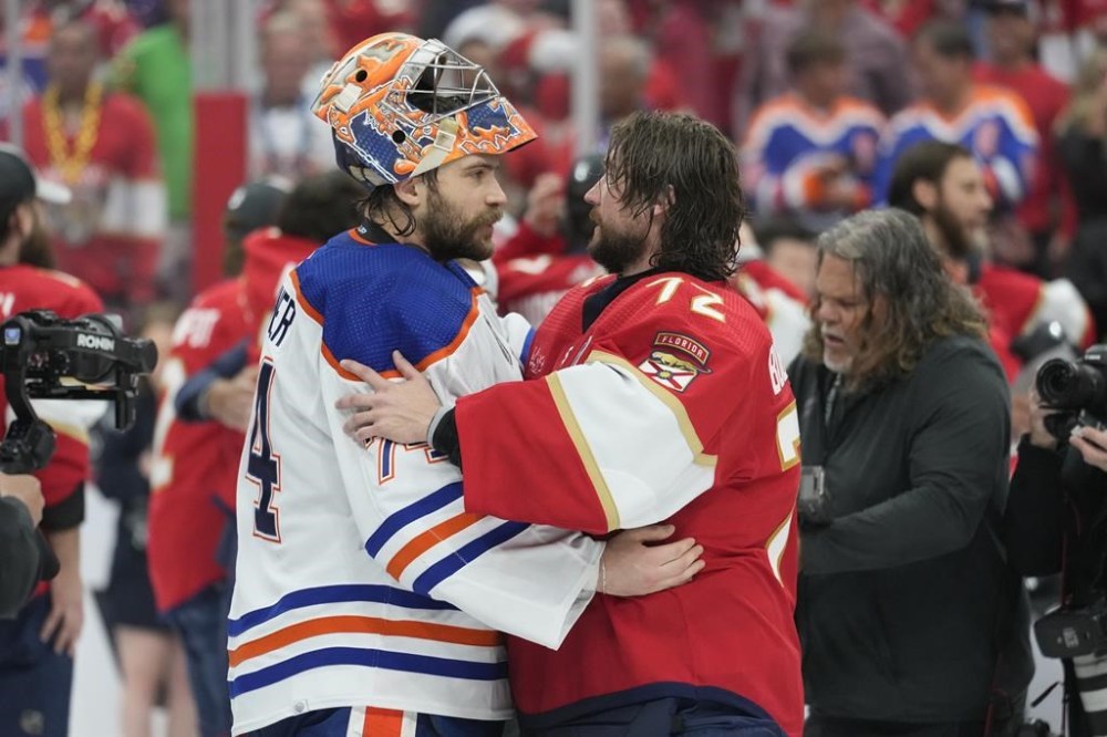 Florida Panthers goaltender Sergei Bobrovsky (72) and Edmonton Oilers goaltender Stuart Skinner, left, talk at the end of Game 7 of the NHL hockey Stanley Cup Final, Monday, June 24, 2024, in Sunrise, Fla. The Panthers defeated the Oilers to win the Stanley Cup. (AP Photo/Wilfredo Lee)