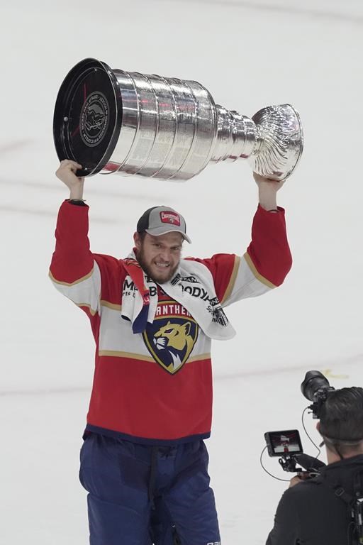 Florida Panthers team captain Aleksander Barkov (16) raises the Stanley Cup trophy after defeating the Edmonton Oilers in Game 7 of the NHL hockey Stanley Cup Final, Monday, June 24, 2024, in Sunrise, Fla. The Panthers defeated the Oilers 2-1. (AP Photo/Rebecca Blackwell)