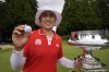 Amy Yang, of South Korea, displays her ball with a smiley face on it as she poses for photos next to the trophy after winning the Women's PGA Championship golf tournament at Sahalee Country Club, Sunday, June 23, 2024, in Sammamish, Wash. (AP Photo/Gerald Herbert)