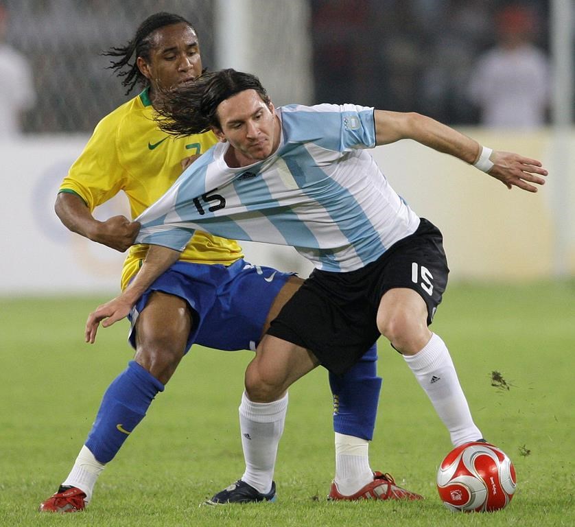 FILE - Argentina's Lionel Messi, front, fights for the ball with Brazil's Anderson during their men's semifinal soccer match at the Beijing 2008 Olympics in China, Tuesday, Aug. 19, 2008. Clubs are not required to release players for the men's Olympic tournament. Inter Miami likely would not be too happy about its just-turned 37-year-old icon playing at the Copa America and the Olympics in the middle of the MLS season. (AP Photo/Petr David Josek, File)