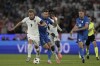 England's Harry Kane, left, runs with the ball ahead Slovenia's Benjamin Sesko during a Group C match between the England and Slovenia at the Euro 2024 soccer tournament in Cologne, Germany, Tuesday, June 25, 2024. (AP Photo/Thanassis Stavrakis)