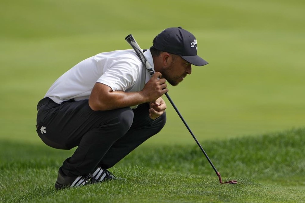 Xander Schauffele lines up a putt on the 18th hole during the final round of the Travelers Championship golf tournament at TPC River Highlands, Sunday, June 23, 2024, in Cromwell, Conn. (AP Photo/Seth Wenig)