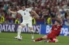 Serbia's Luka Jovic, left, avoids the challenge from Denmark's Pierre-Emile Hojbjerg during a Group C match between the Denmark and Serbia at the Euro 2024 soccer tournament in Munich, Germany, Tuesday, June 25, 2024. (AP Photo/Antonio Calanni)
